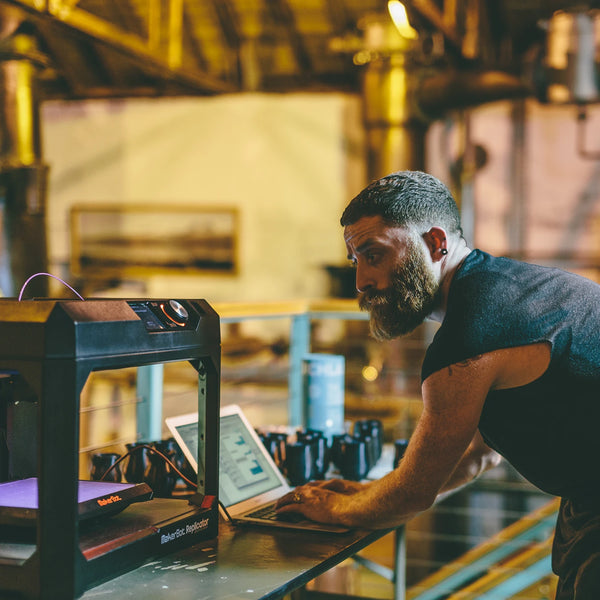 Designer Sruli Recht working on a MakerBot 3D printer to create prototypes of the Norlan Whisky Glass