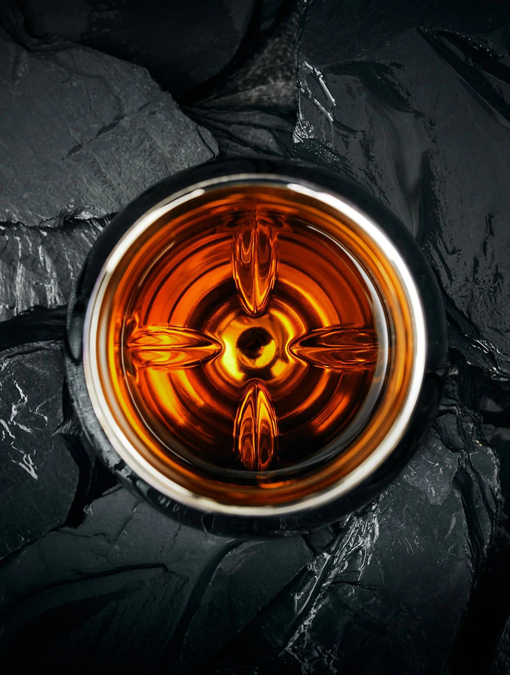 Looking down into the Norlan Steel Tumbler with a burnt orange whiskey inside.