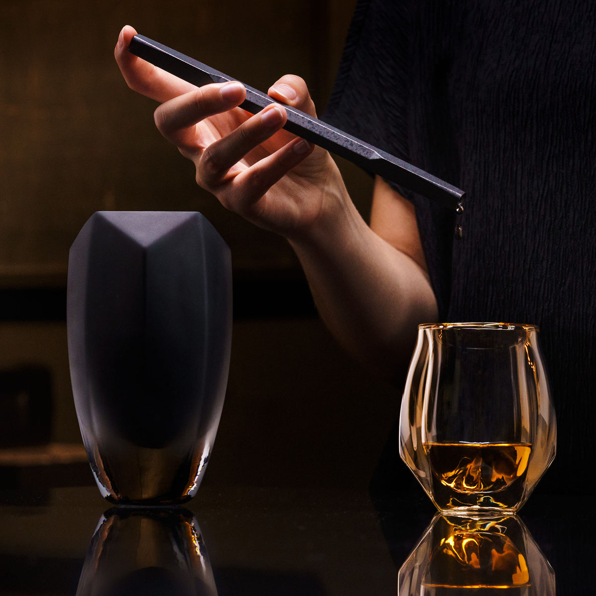 A water pipette being used to add water to whisky