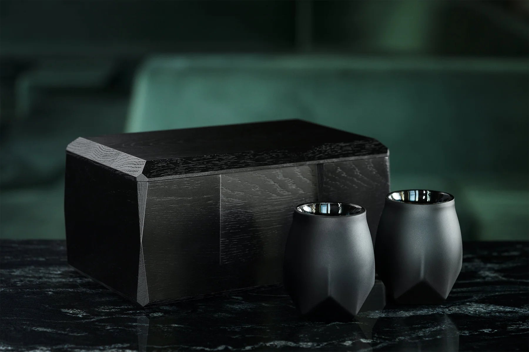 Kist by Two storage case for Norlan Glasses shown sitting on a black marble table with two Norlan Whisky Glasses (VAILD (Black)