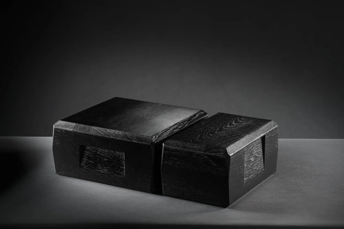 A lifestyle image of the Kist by two and kist by four storage cases sitting on a matte grey table side by side