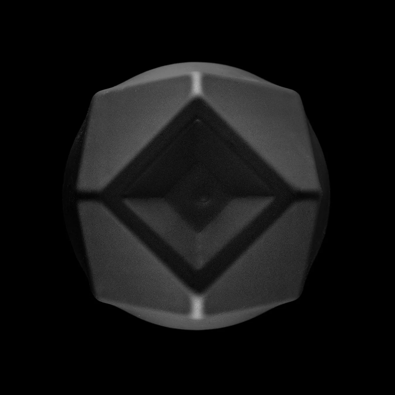 Bottom view of the matte black Norlan Whisky Glass, highlighting its geometric shape in bososilicate glass