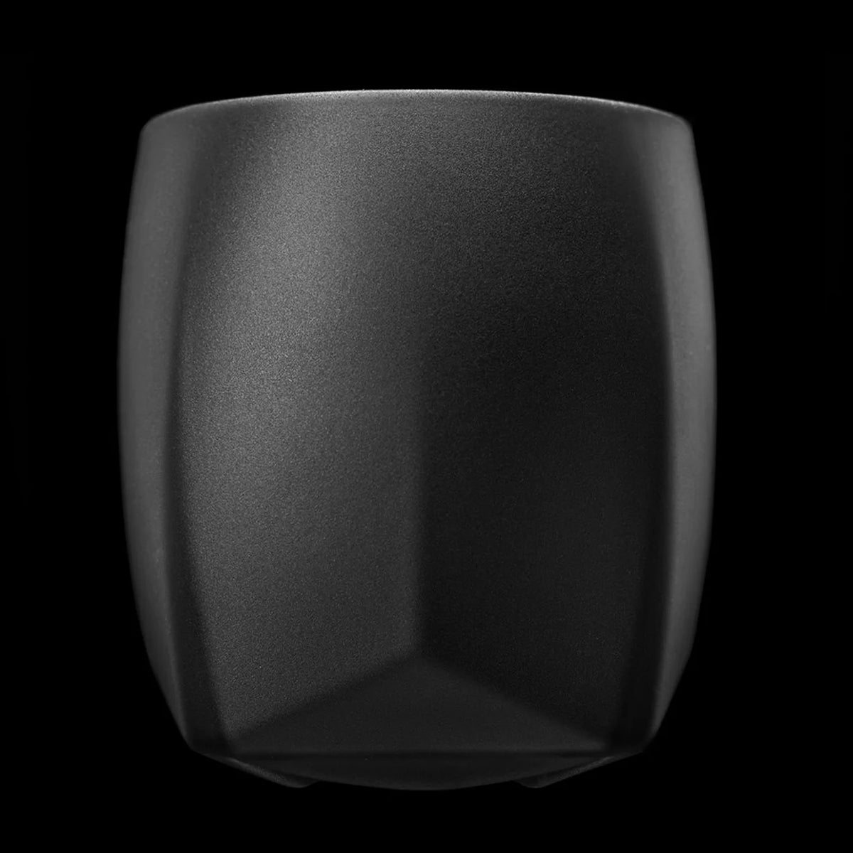 An elegant matte black whiskey tumbler featuring a faceted profile, ideal for sipping whisky on ice or with crafted cocktails